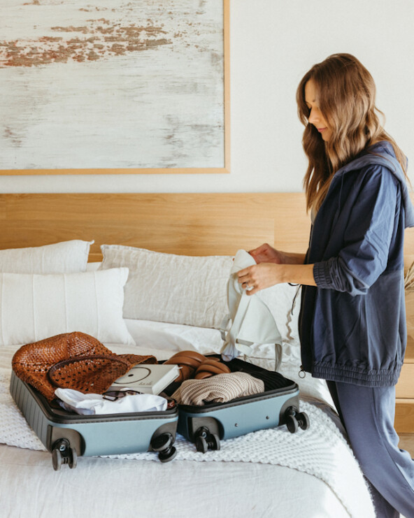 Woman packing suitcase.