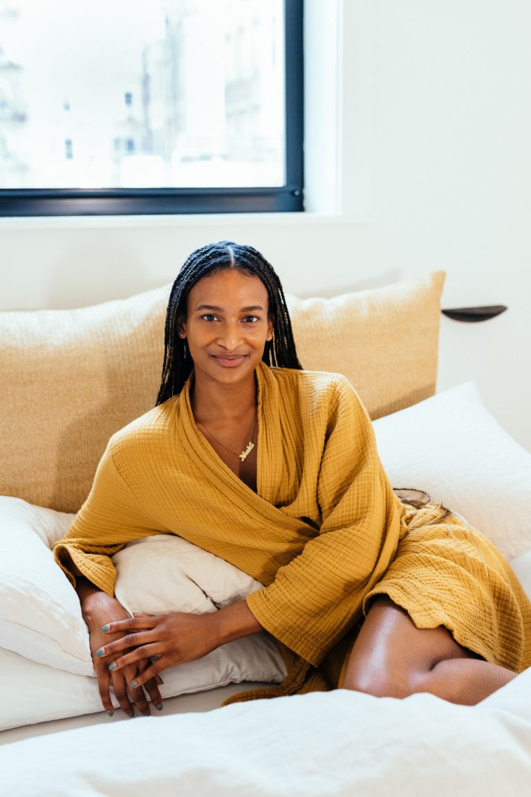 Woman wearing loungewear in bed.