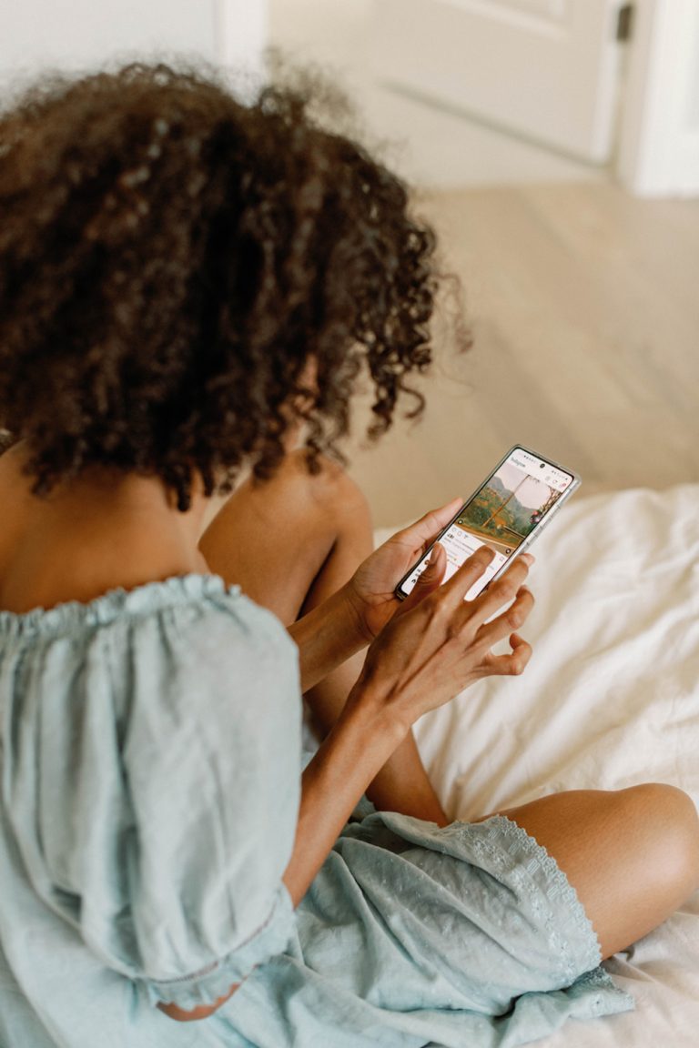 Woman scrolling on phone.