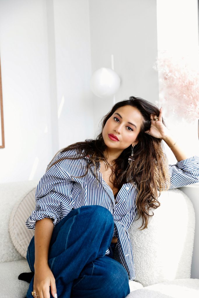 Woman sitting on couch.