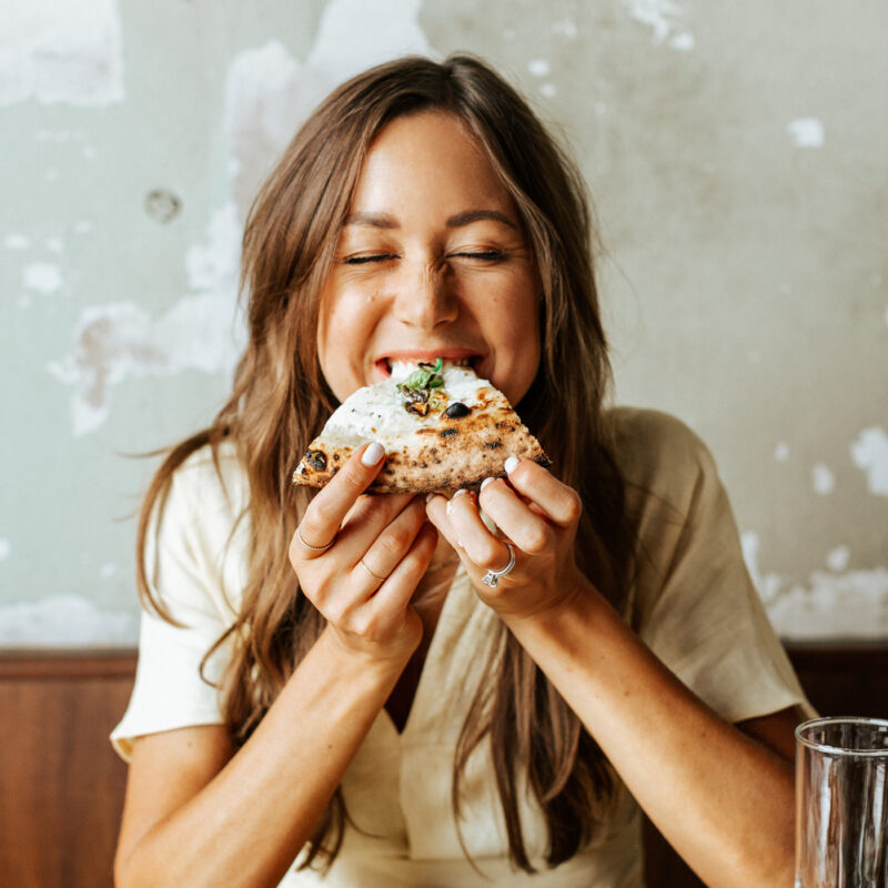Camille eating pizza