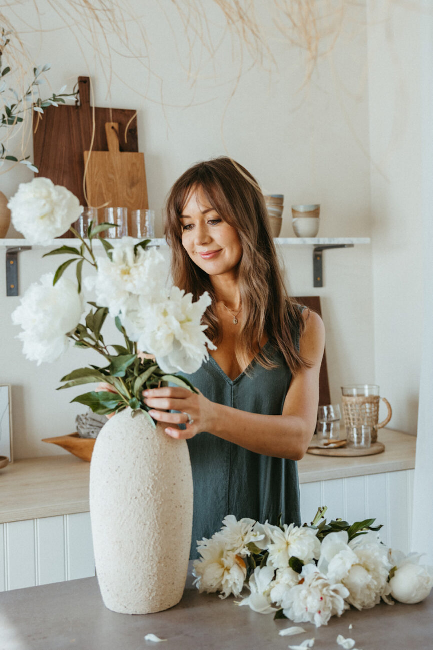 Camille Styles arranging flowers.