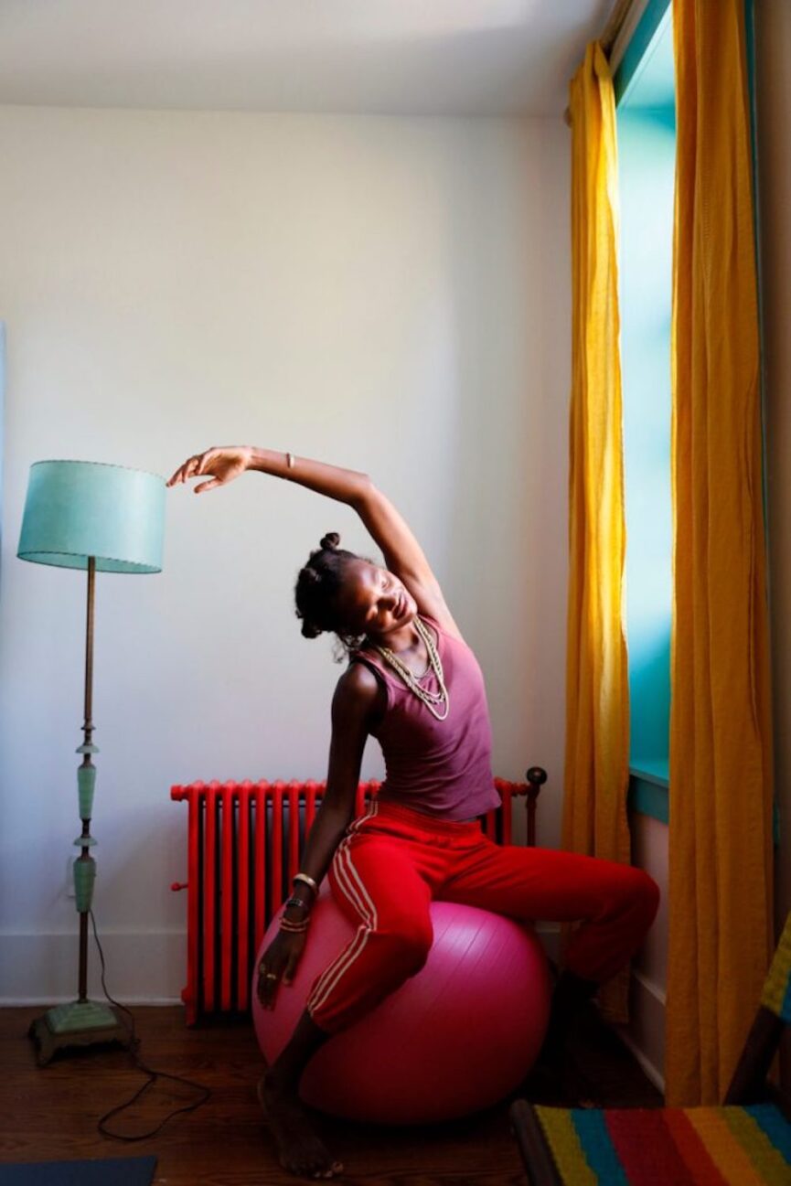 Woman stretching connected workout ball.