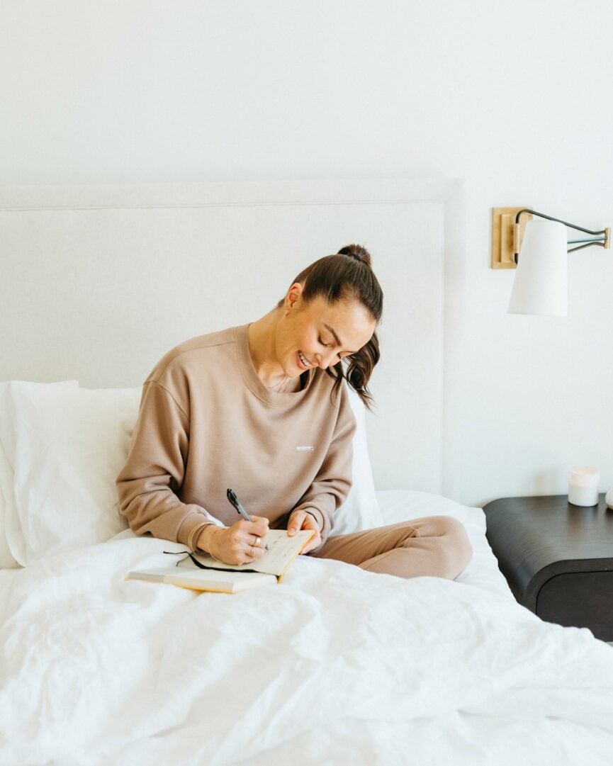 woman journaling in bed
