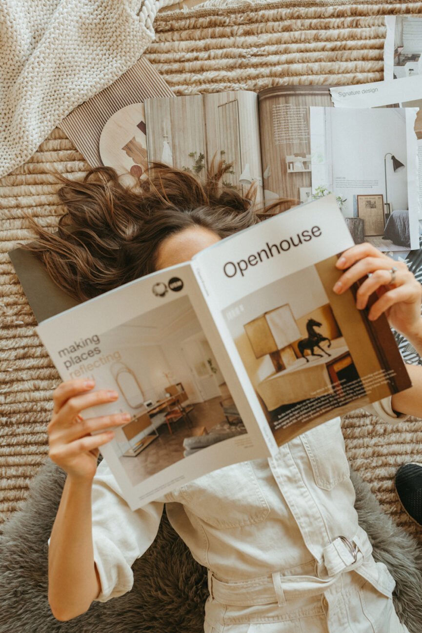 woman reading magazines on the floor
