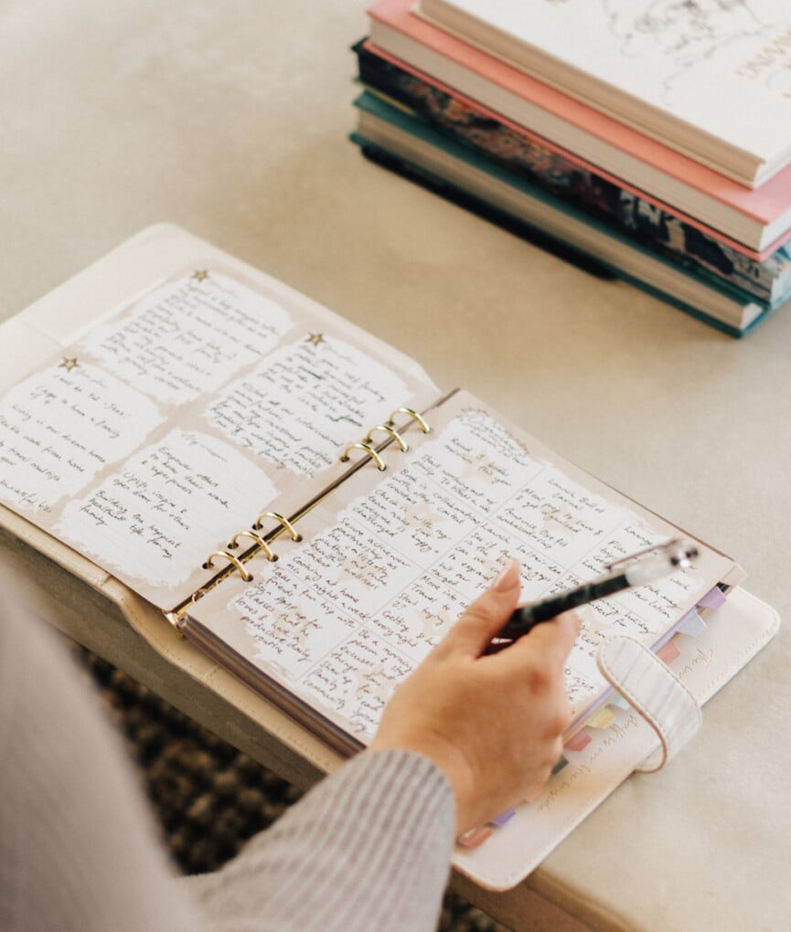 Woman writing in notebook.