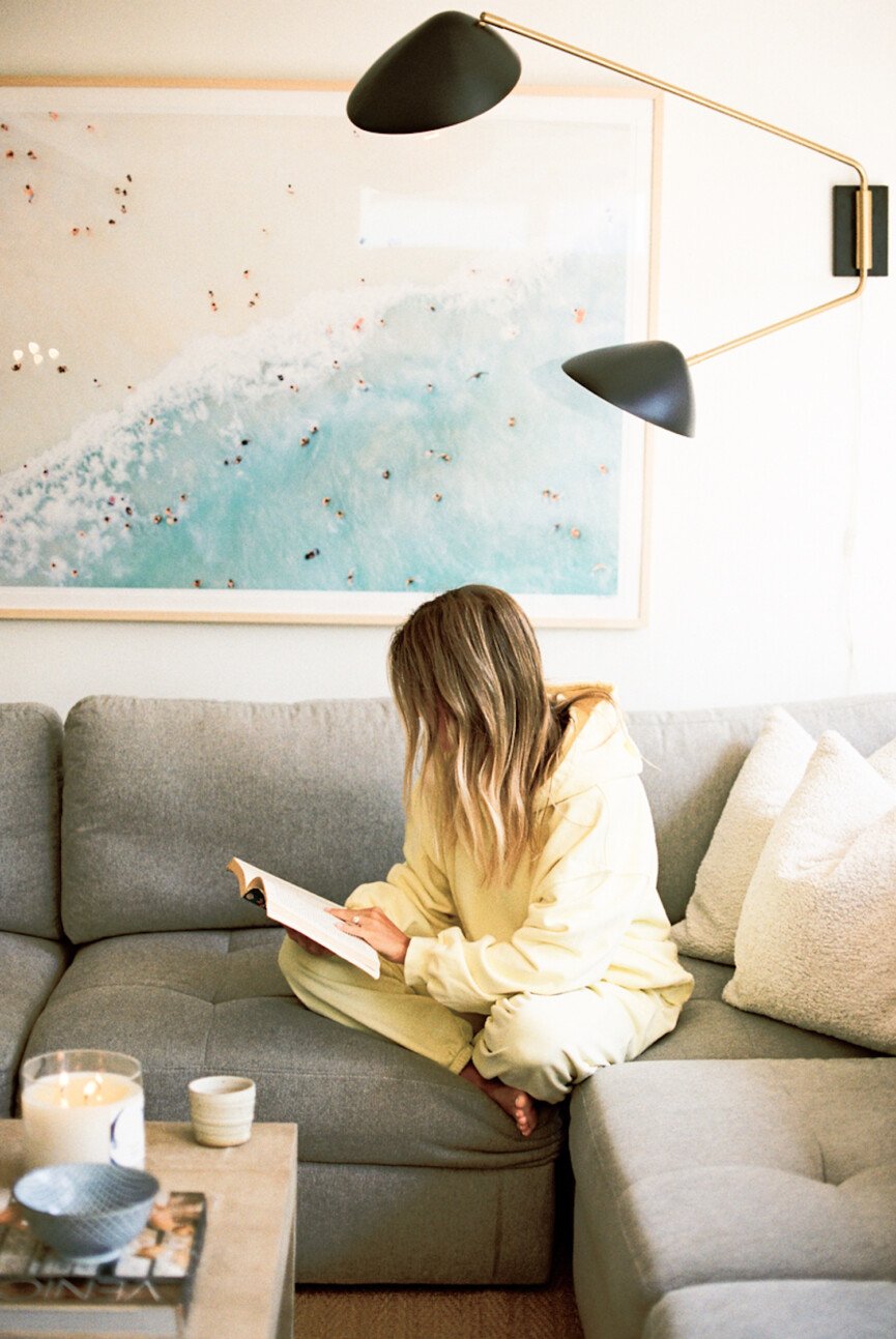 Woman reading on couch.