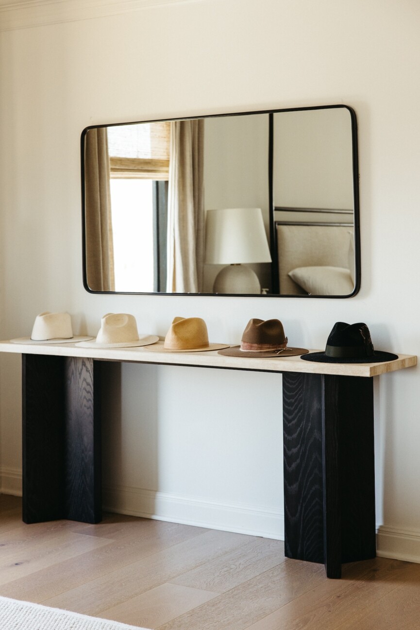 hats on console table with mirror