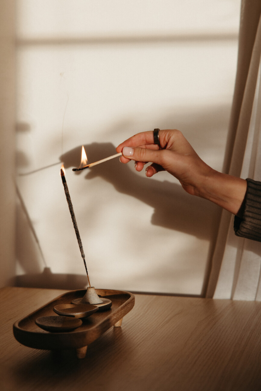 Woman lighting incense.