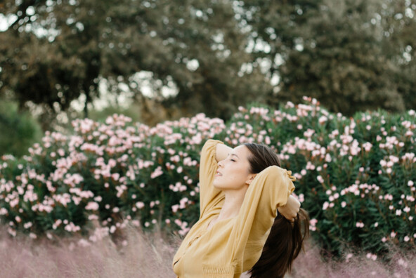 Woman wearing yellow dress outside.