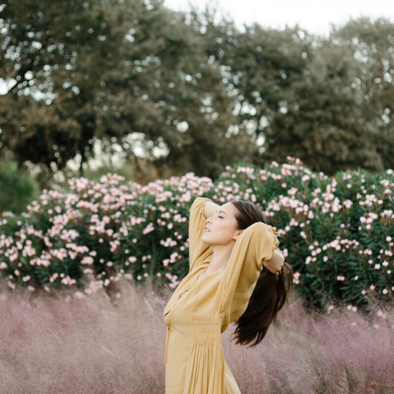 Woman wearing yellow dress outside.