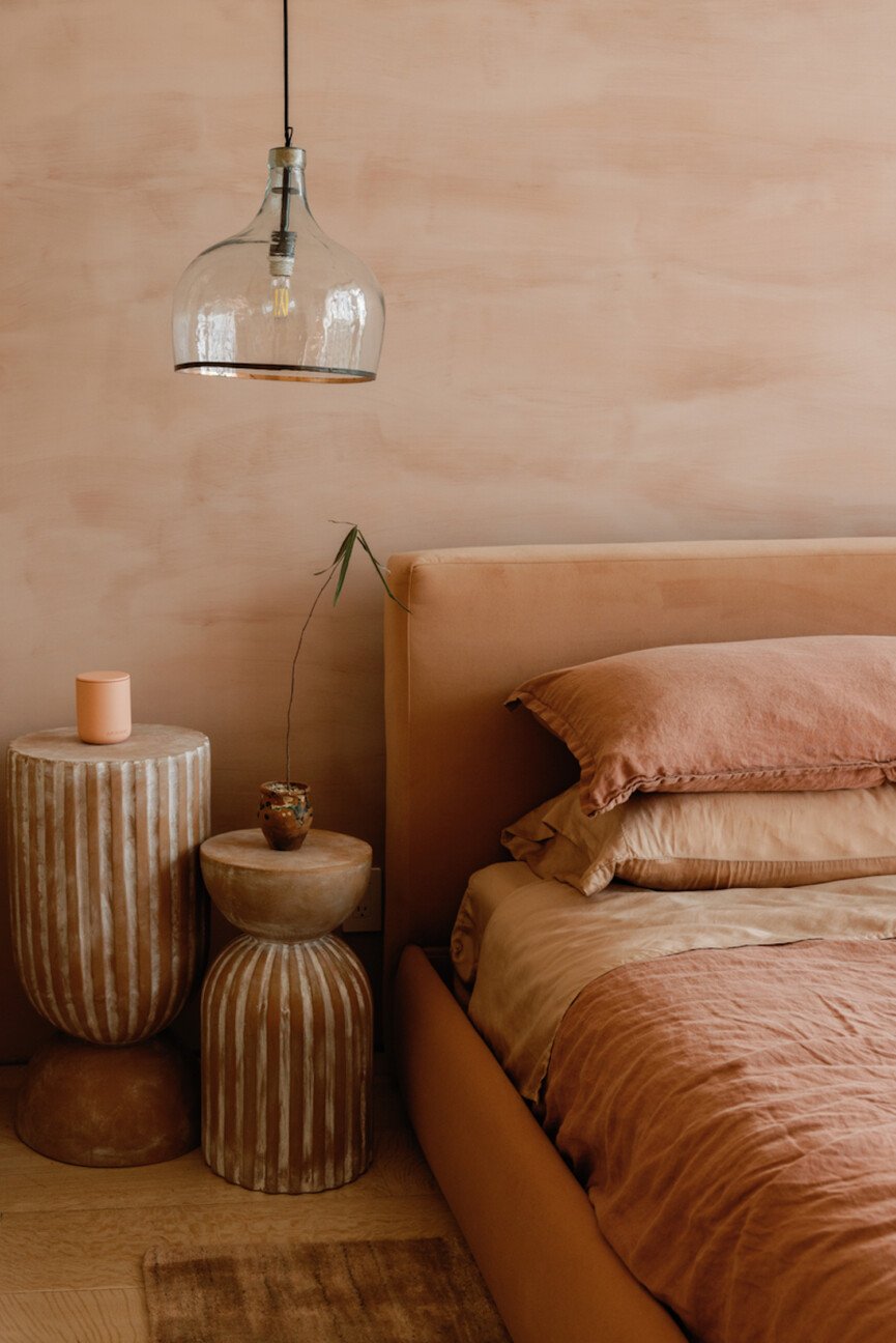 Pink terracotta bedroom with linen sheets.