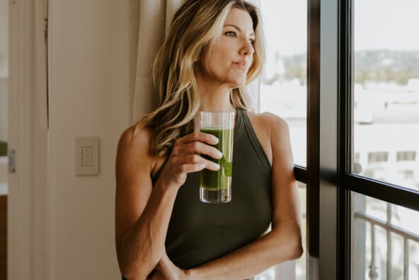 Woman drinking green juice.