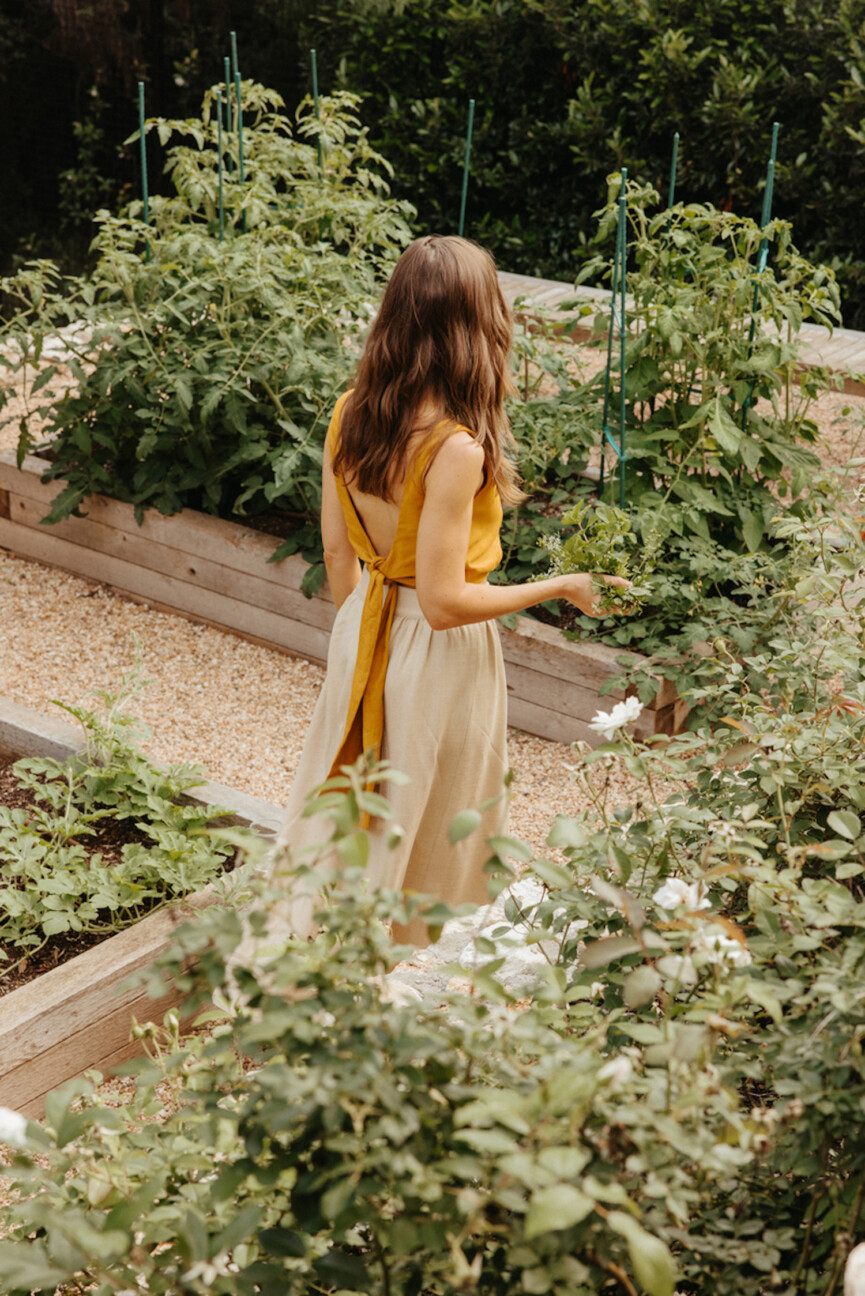 Woman walking in garden.