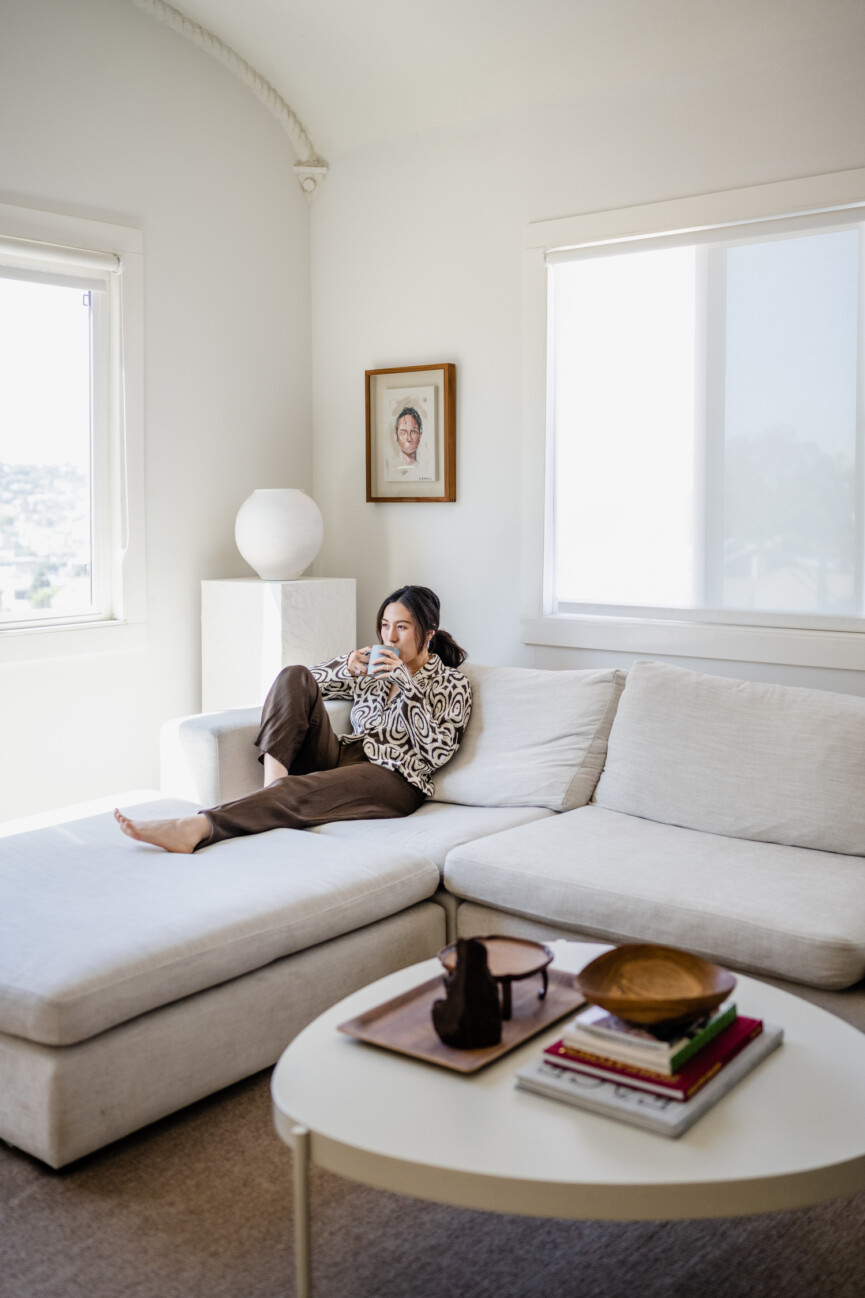 Diana Ryu drinking coffee on the sofa