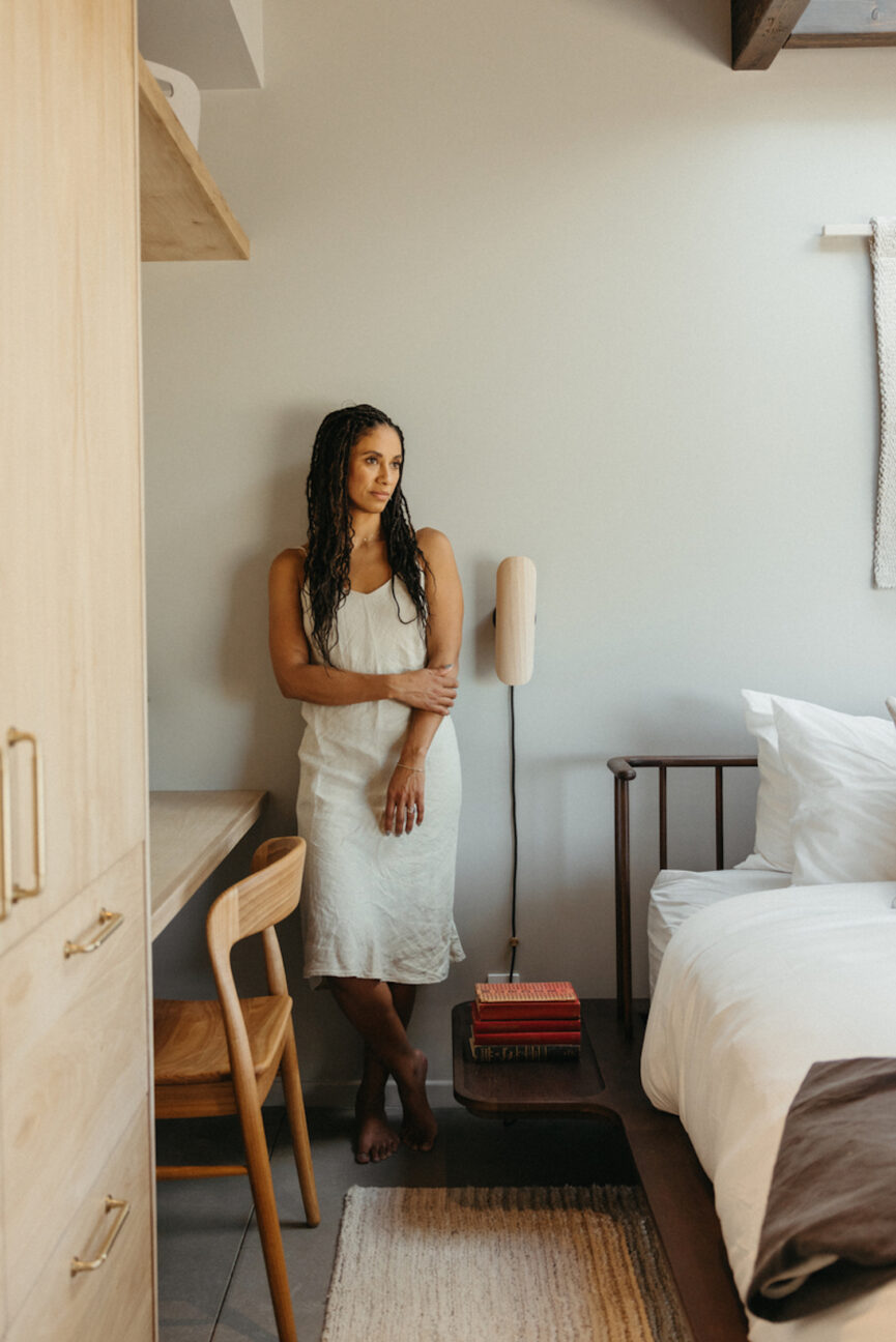 Woman posing in bedroom.