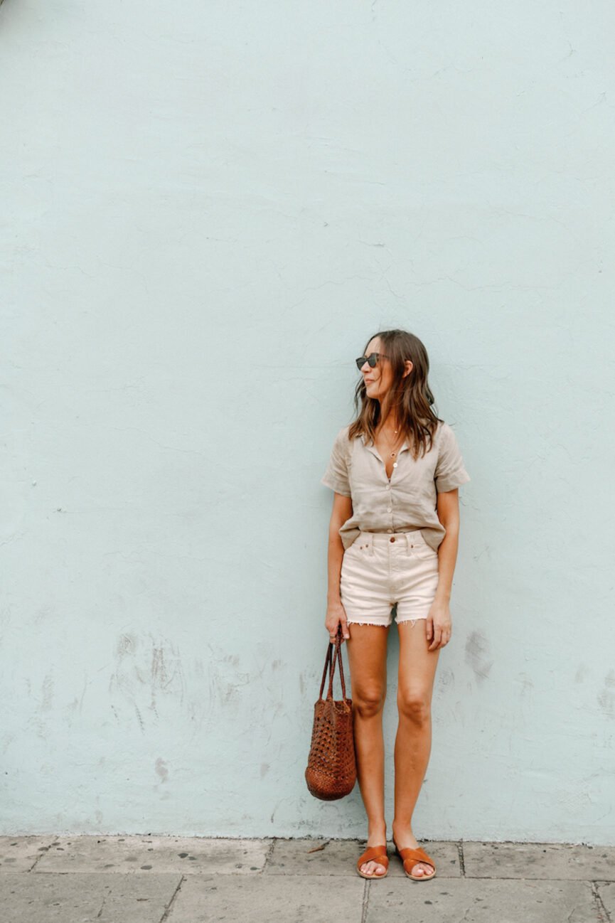 Camille Styles wearing linen top and denim shorts.