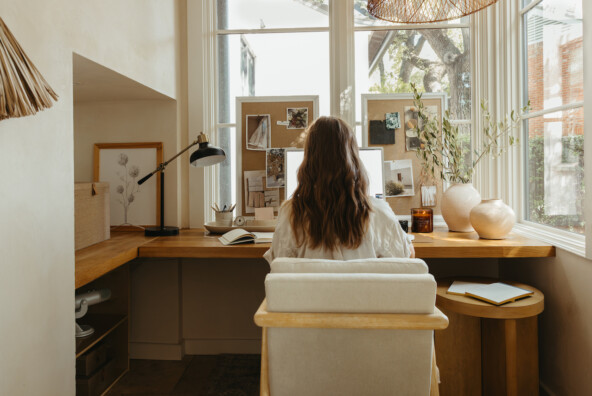 Camille Styles working at desk.