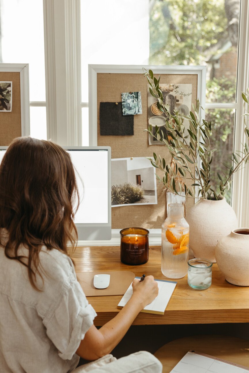 Camille Styles writing at desk