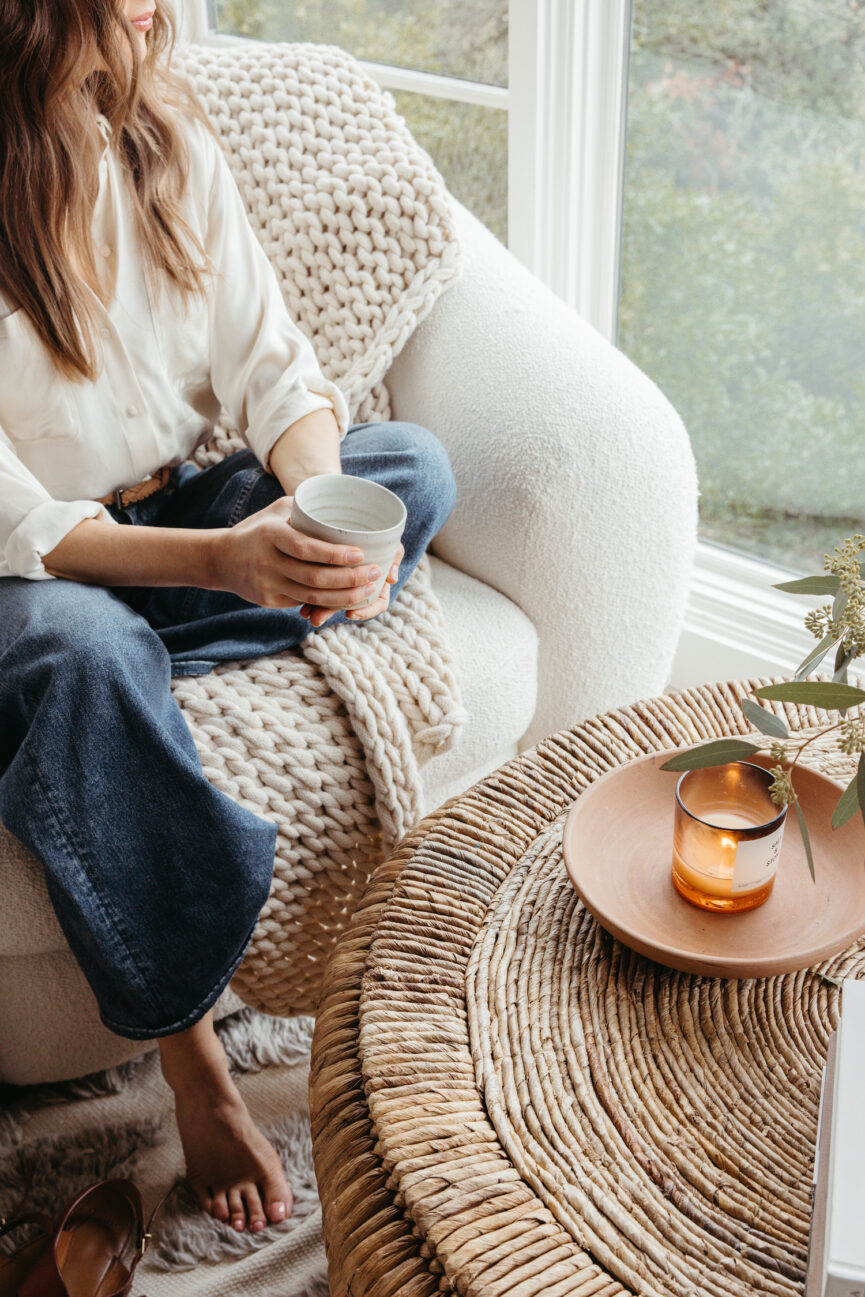 Camille Styles sitting at the coffee table