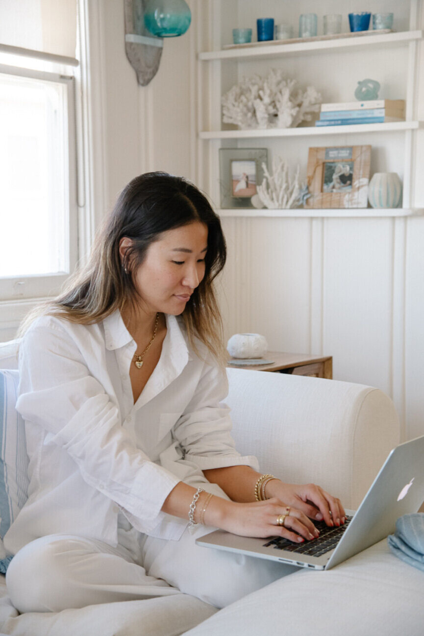 Woman typing on computer practicing habit hacks.