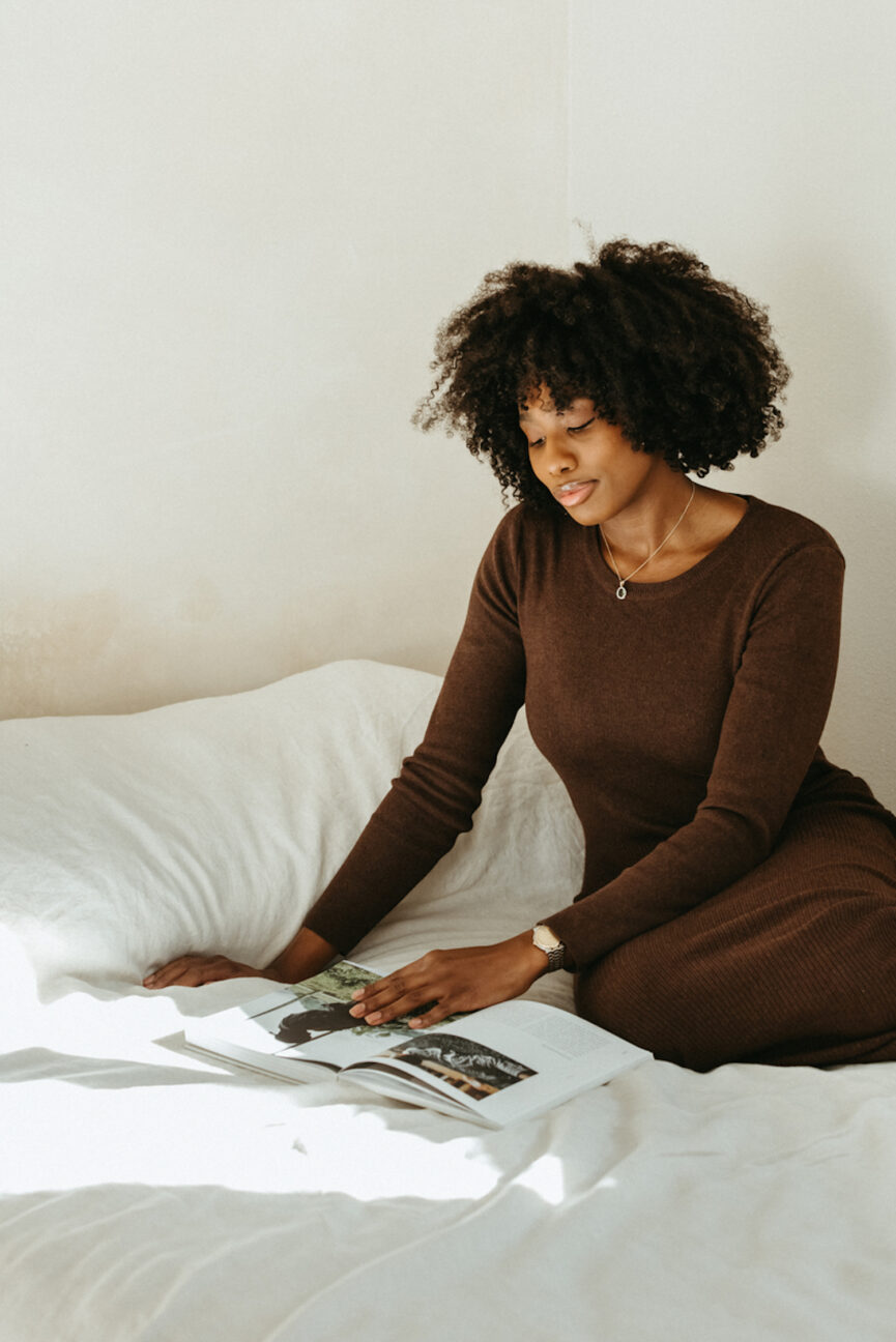 Woman reading book in bed.