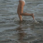 Woman running in water.