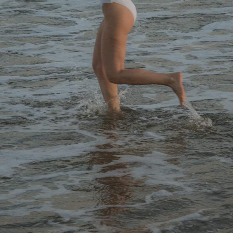 Woman running in water.