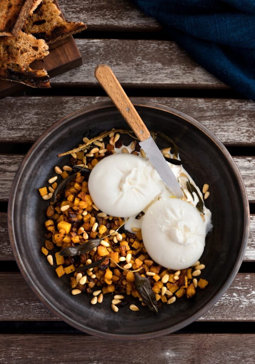 burrata with caramelized squash, pine nuts, and golden raisins