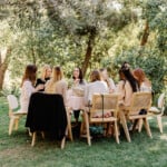 Women gathered around table at a 40th birthday dinner.