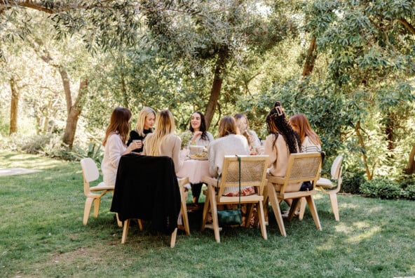 Women gathered around table at a 40th birthday dinner.