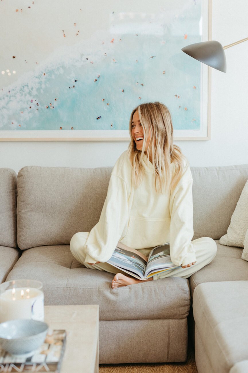 Woman journaling on the couch.