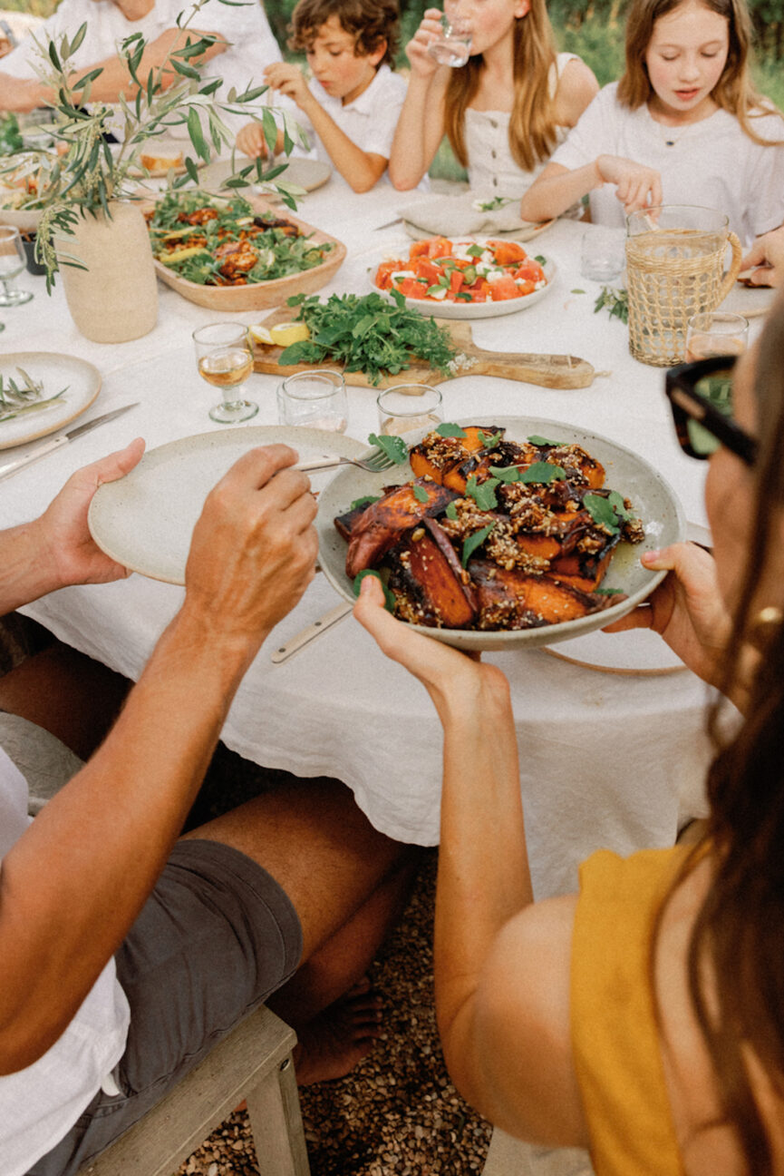 Passing food at dinner party