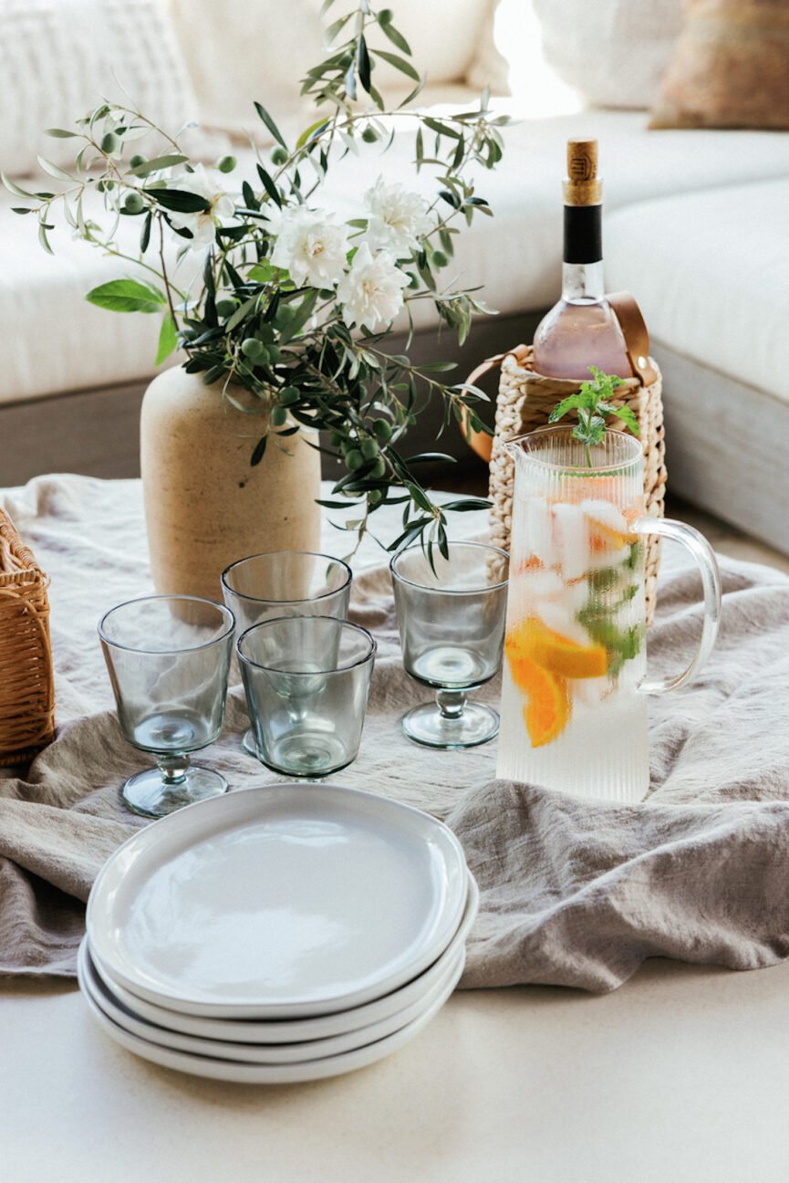 Stacked plates and glassware at dinner party