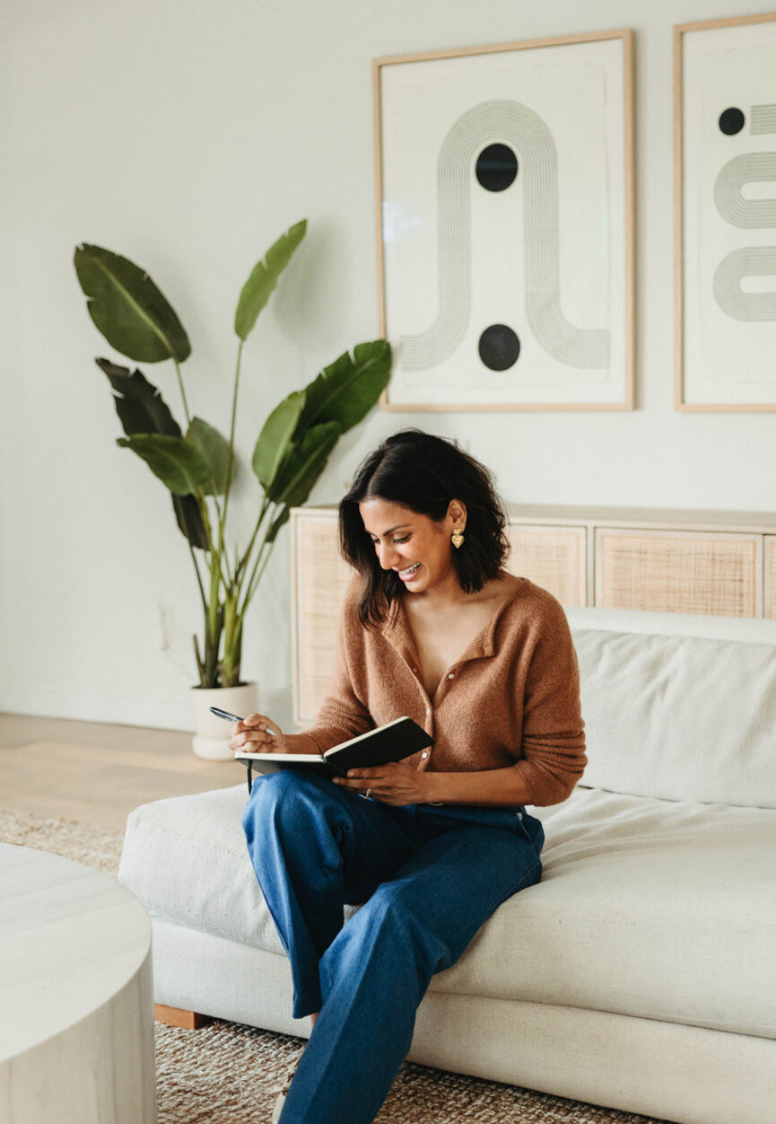 Woman journaling on couch