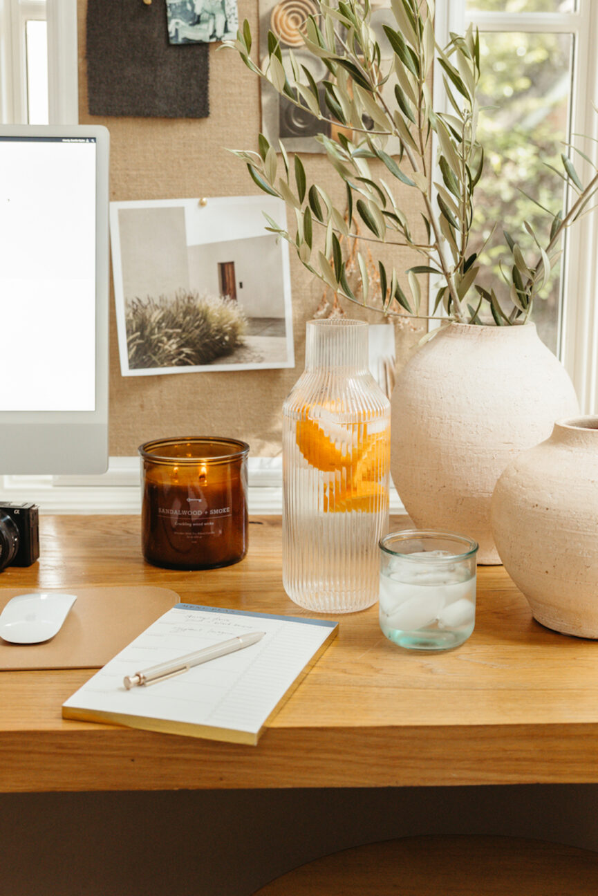 Water pitcher and glass and desk accessories.