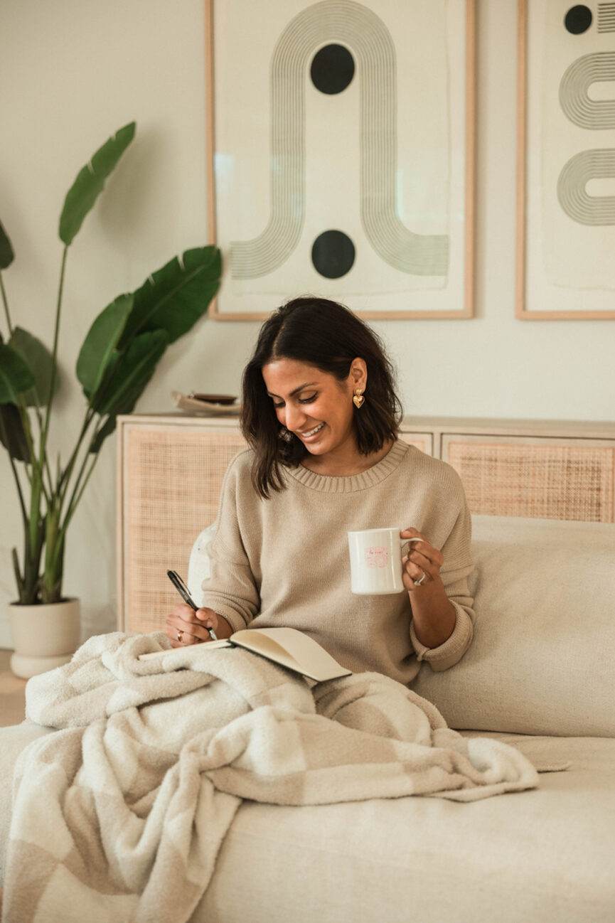 Woman writing diary in bed.