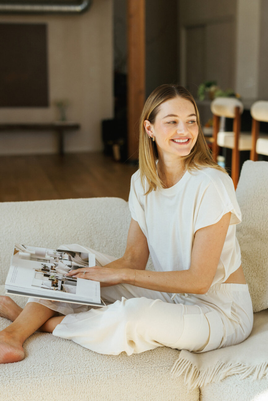 Woman reading article about social media boundaries on couch.