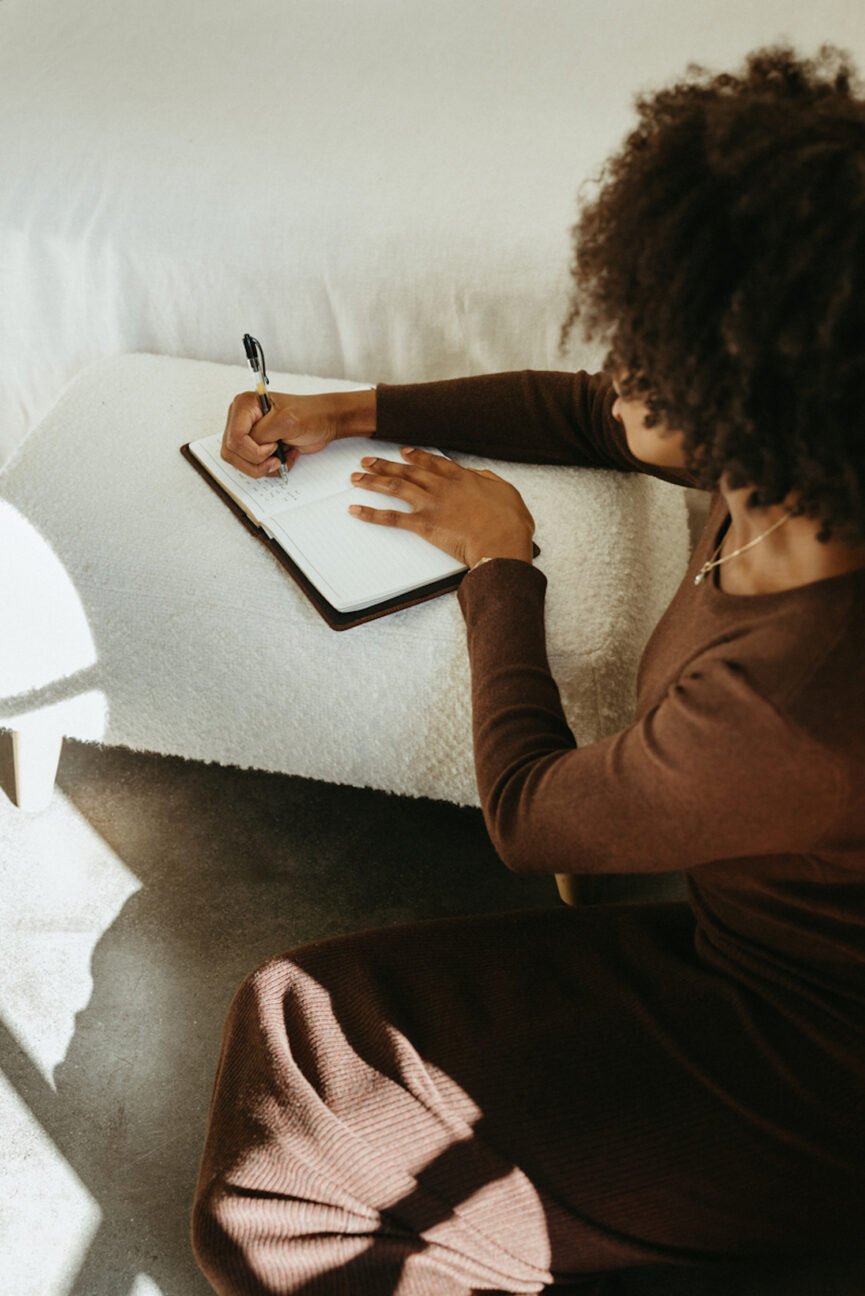 Woman writing in journal.