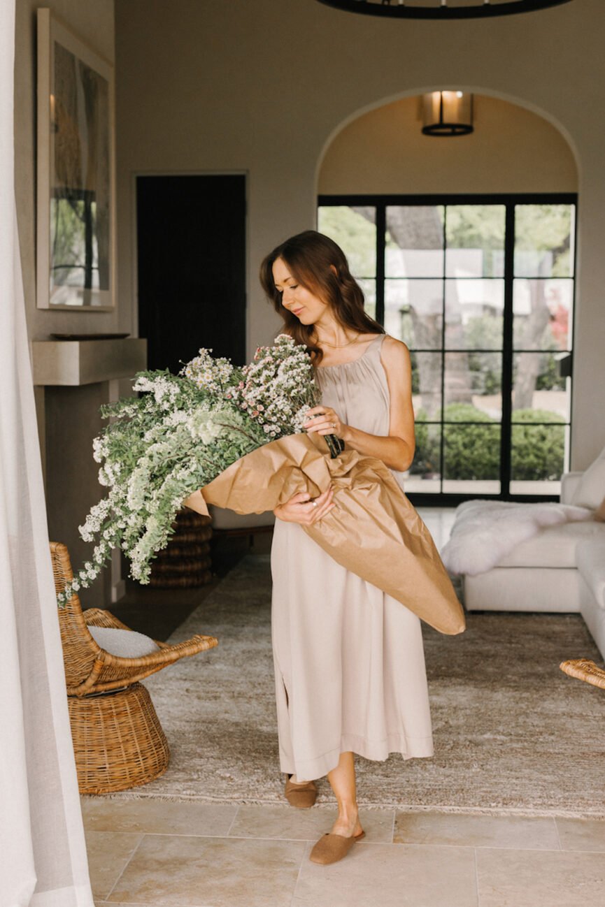 Camille Styles holding flower arrangement