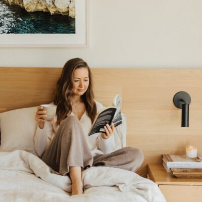 Camille Styles reading in bed.