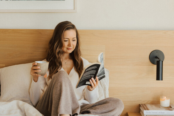 Camille Styles reading in bed.