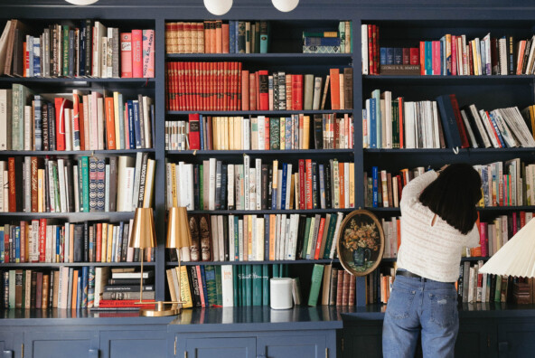 Kate Arenda and a blue bookshelf