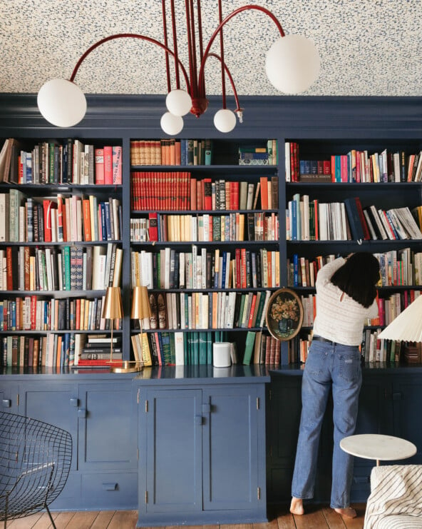 Kate Arenda and a blue bookshelf