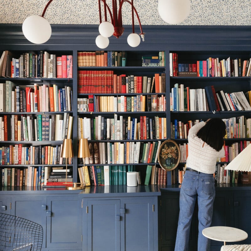 Kate Arenda and a blue bookshelf