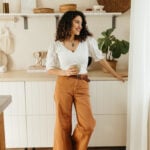 Woman drinking coffee in a coffee nook.