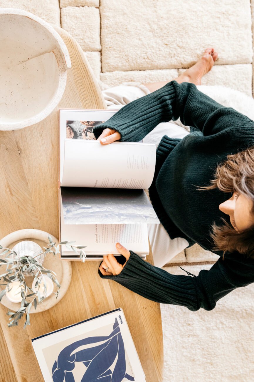 Woman reading coffee table book