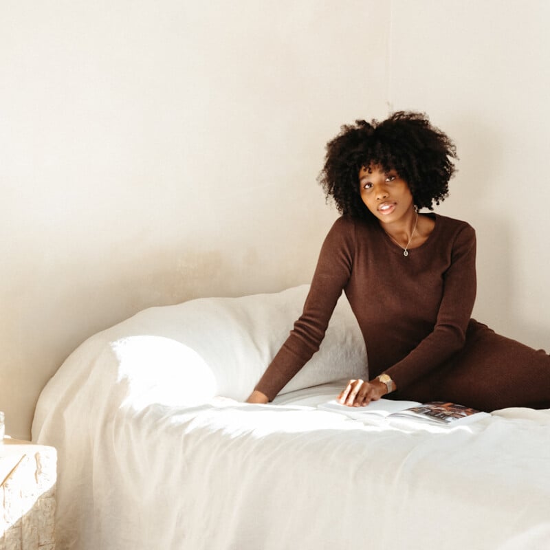 Woman reading on bed with candle