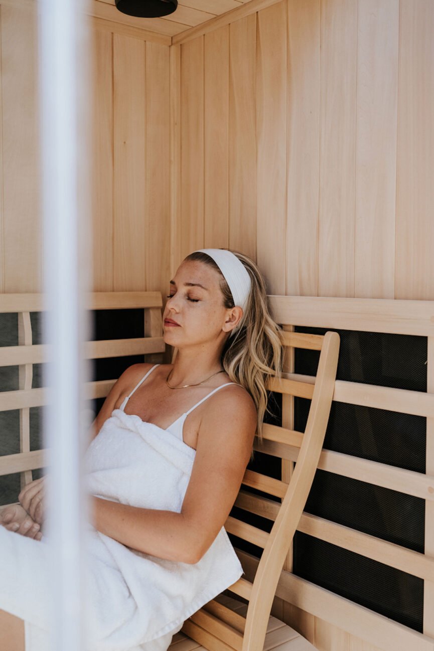 Woman sitting in sauna.