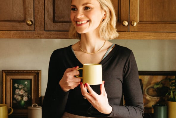 woman holding favorite things party mug